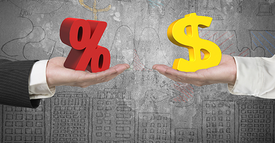 One hand holds a 3D percent sign while another hand holds a 3D dollar sign in font of a gray background with a hand drawn sky line and statistics.